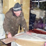 Loughie working on the sails for Douglas' boat. Photo: SR